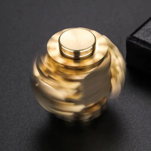 Premium brass fidget spinner close-up showing polished metal body and smooth rotation"
