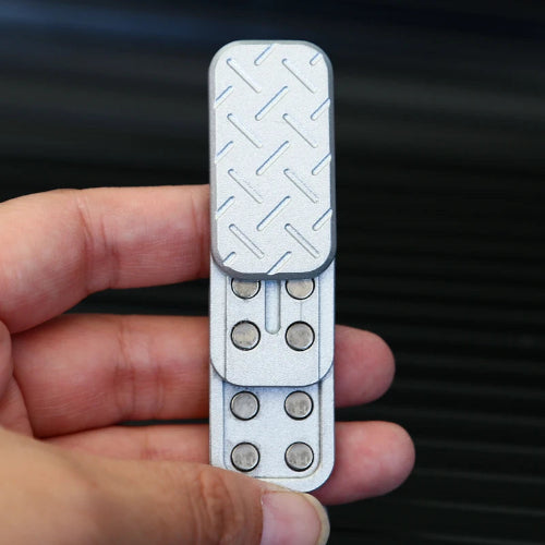 Close-up of Magnetic Toy Silver metal fidget slider on desk