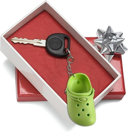 Floating Foam mini Croc Green keyring attached to a key inside a gift box