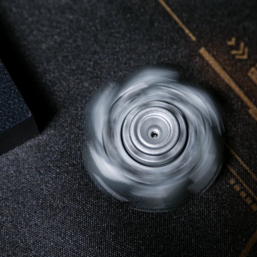 Linkage Fidget Spinner black spinning on desk – quiet fingertip gyro fidget toy for anxiety relief and stress reduction