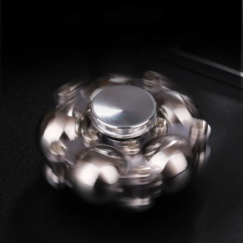 Close-up of Stress Relievers for Adults metal fidget spinner toy spinning smoothly on wooden table for relaxation and ADHD focus