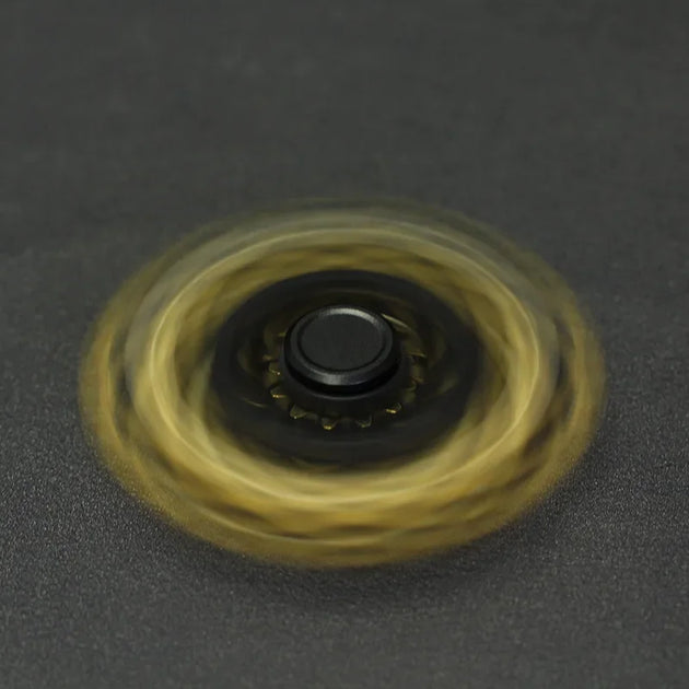 hand holding fidget spinner gears stress relief focus tool