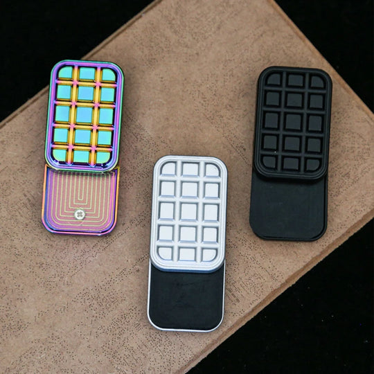 hand holding chocolate-style magnetic fidget slider at office desk