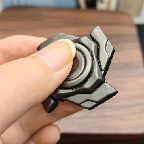 Magnetic open-armor spinning top fidget toy on desk setup