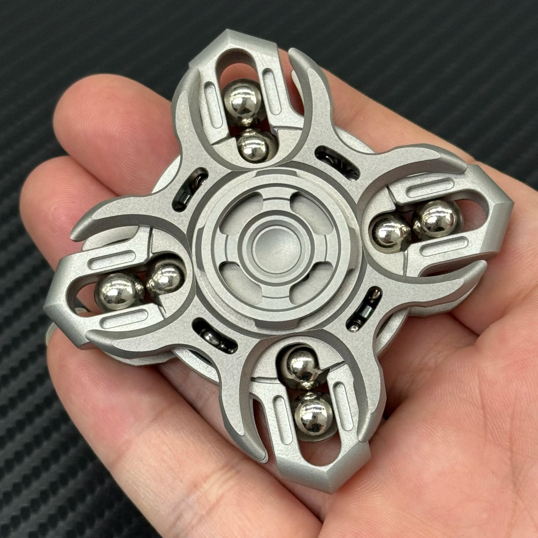 Metal Future Punk EDC Spinner shown in hand from front-facing angle