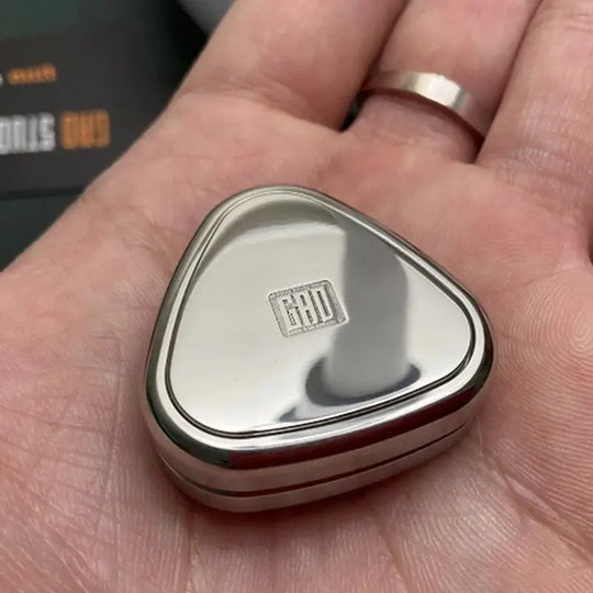 MAG A magnetic Rice Ball Fidget Slider toy in silver, held in hand to show compact EDC size