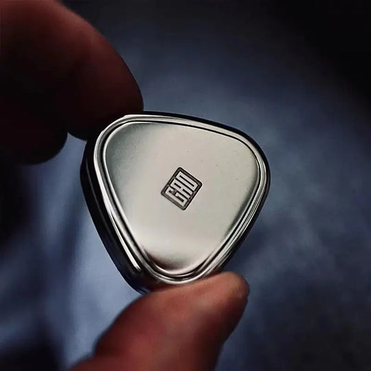 Close-up of Rice Ball Fidget Slider toy with square logo design on smooth metallic surface