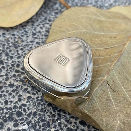Stainless steel Rice Ball Fidget Slider toy displayed on a leaf for aesthetic close-up