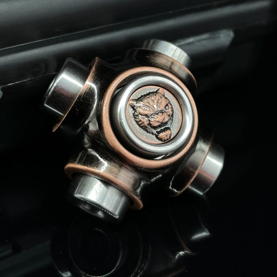 Close-up of X-BONE Tiger Spinner fidget on black surface